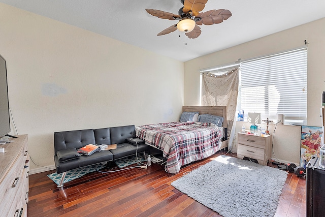 bedroom with dark wood-type flooring and ceiling fan