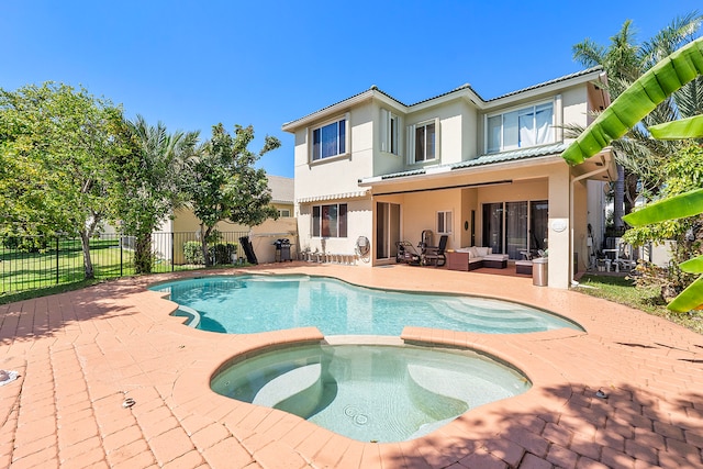 view of pool with a patio area, an in ground hot tub, and an outdoor hangout area