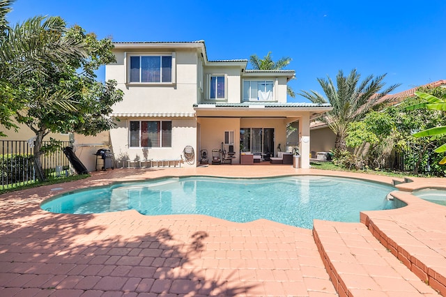 view of swimming pool with a patio and an in ground hot tub