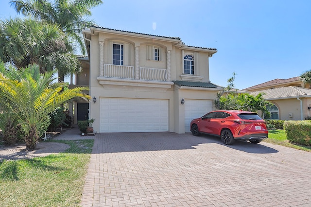 mediterranean / spanish-style house with a garage