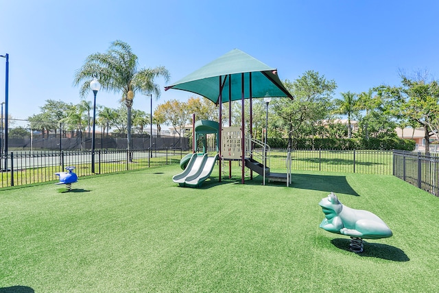 view of jungle gym featuring a lawn