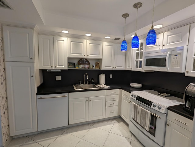 kitchen with hanging light fixtures, sink, white appliances, and white cabinets