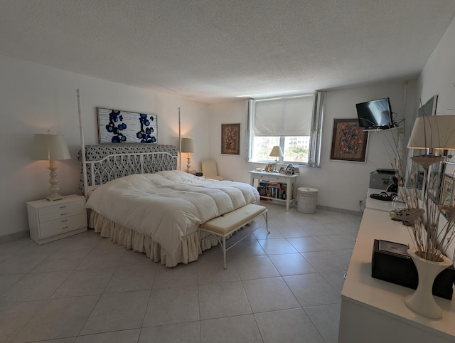 tiled bedroom featuring a textured ceiling