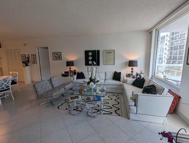 living room with a textured ceiling and light tile patterned floors