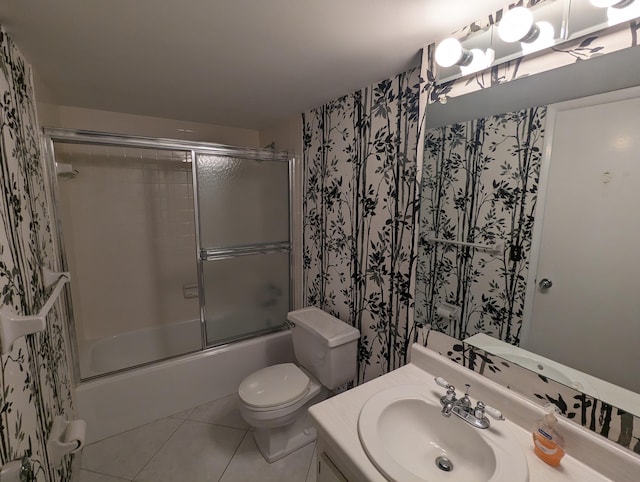 full bathroom with tile patterned floors, shower / bath combination with glass door, toilet, and vanity