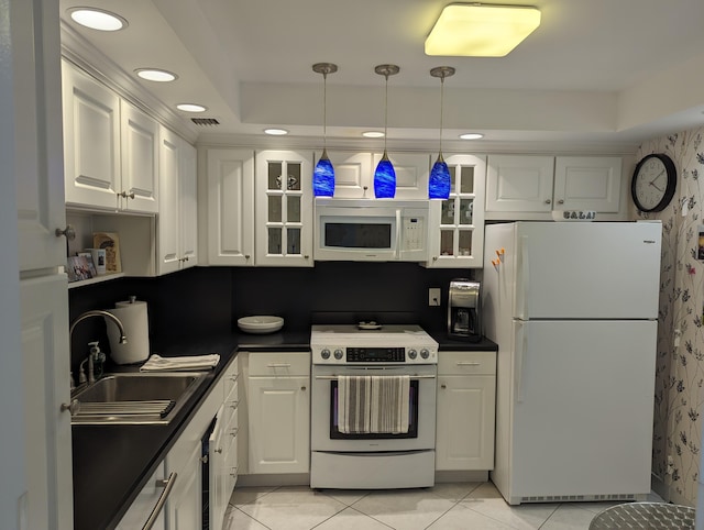 kitchen with decorative light fixtures, white appliances, white cabinetry, sink, and light tile patterned flooring