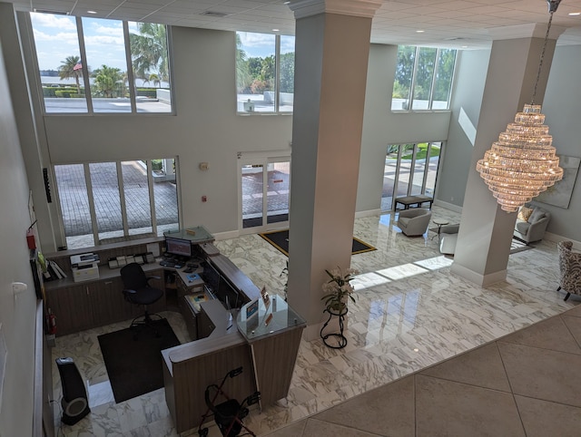 interior space with a towering ceiling and light tile patterned flooring