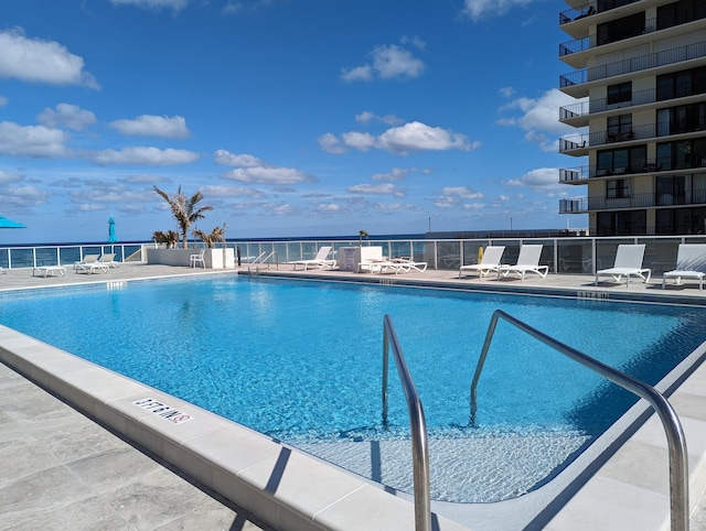 view of pool featuring a water view