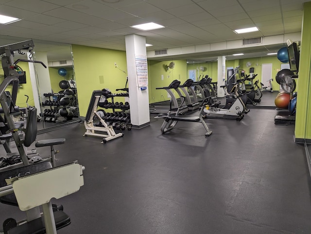 exercise room featuring a drop ceiling