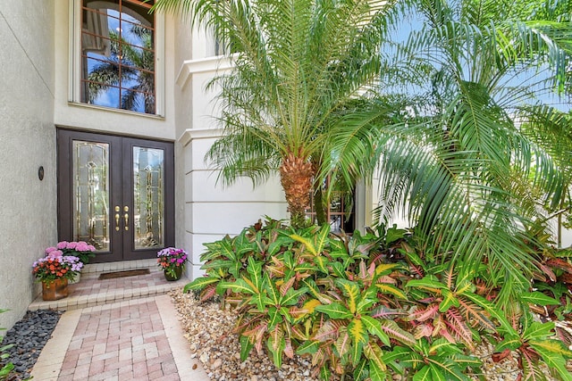 property entrance featuring french doors and stucco siding