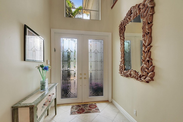 foyer featuring light tile patterned floors, french doors, and baseboards