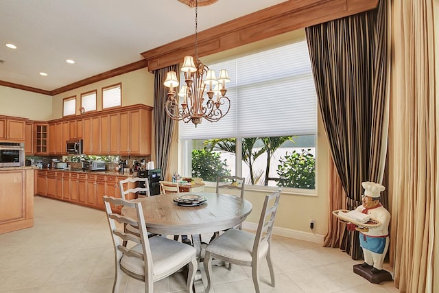 tiled dining room with a wealth of natural light, an inviting chandelier, and ornamental molding