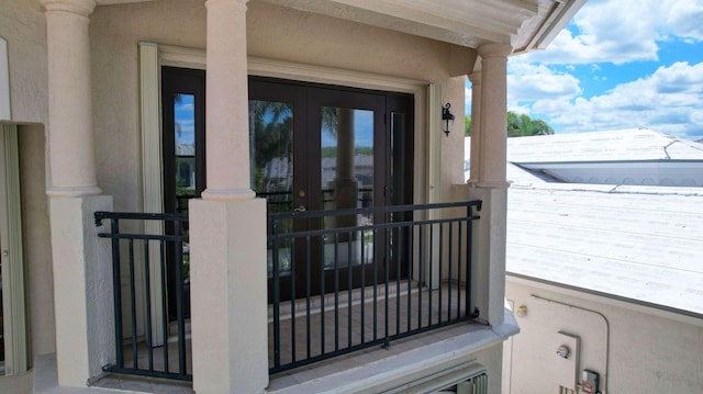 doorway to property featuring a balcony and stucco siding