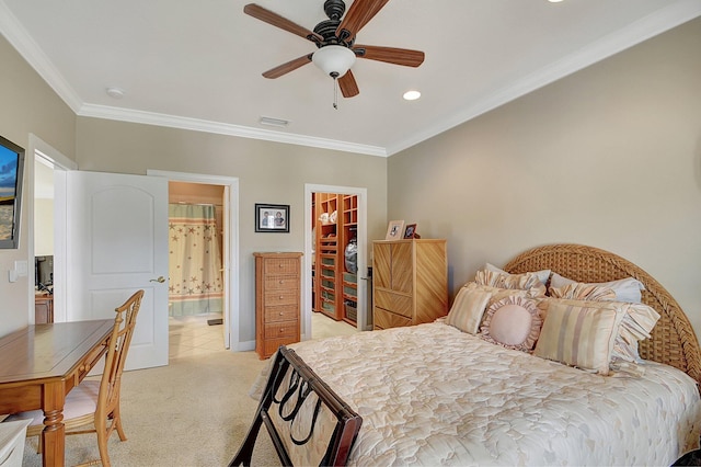 carpeted bedroom featuring a spacious closet, a closet, connected bathroom, ornamental molding, and ceiling fan