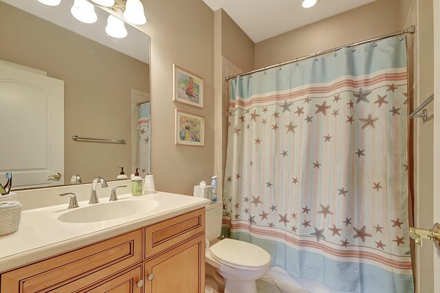 bathroom with vanity, toilet, walk in shower, and tile patterned floors