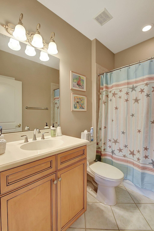 bathroom featuring a shower with shower curtain, vanity, toilet, and tile patterned floors