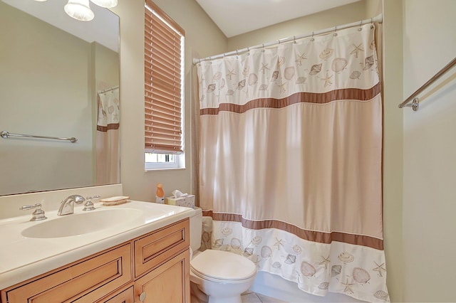 bathroom featuring a shower with curtain, toilet, and vanity