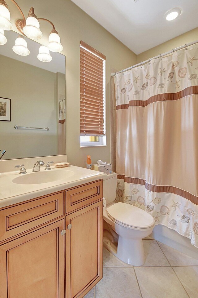 bathroom featuring vanity, toilet, a shower with curtain, and tile patterned floors