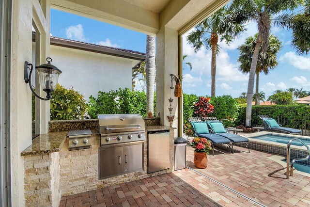 view of patio / terrace with grilling area and an outdoor kitchen