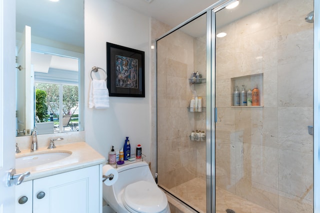 bathroom with a shower with shower door, toilet, and vanity