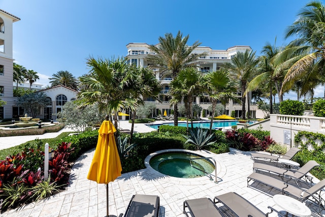 view of nearby features with a patio area and a swimming pool with hot tub