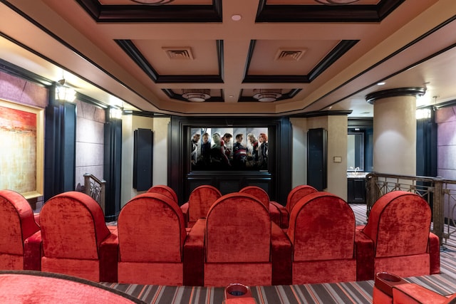 carpeted cinema room featuring ornamental molding, ornate columns, and coffered ceiling