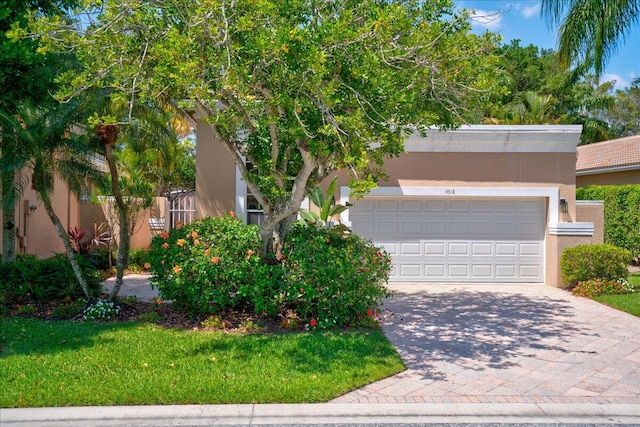 view of front of property featuring a garage and a front lawn