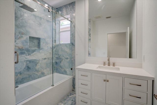 bathroom with vanity and combined bath / shower with glass door