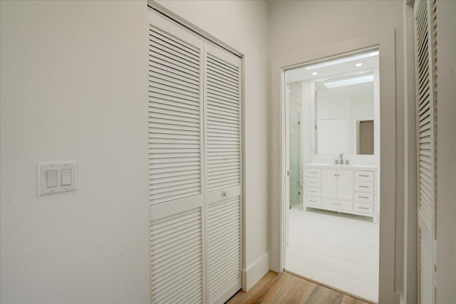 hall featuring light hardwood / wood-style flooring and sink