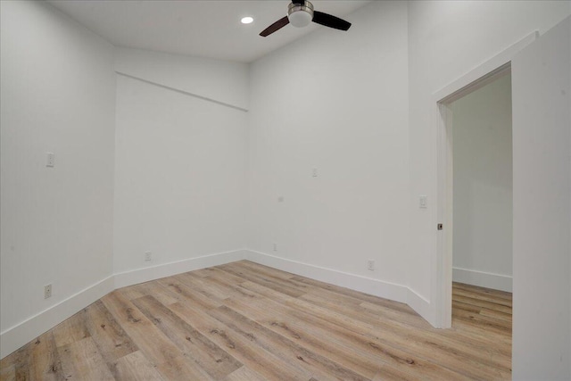 unfurnished room featuring vaulted ceiling, ceiling fan, and light wood-type flooring