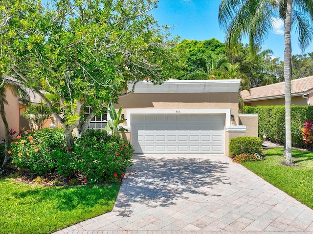 view of front of home with a front yard and a garage