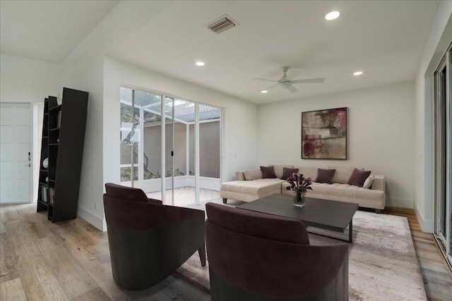 living room with ceiling fan and light wood-type flooring