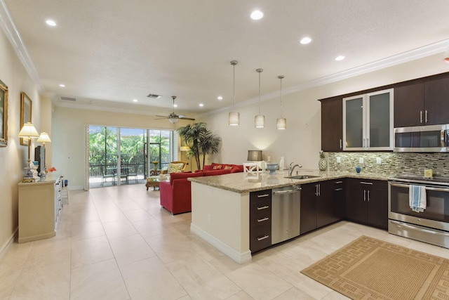 kitchen featuring appliances with stainless steel finishes, dark brown cabinets, ceiling fan, crown molding, and sink