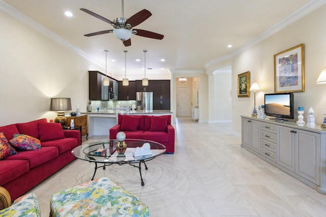 living room with ceiling fan and crown molding