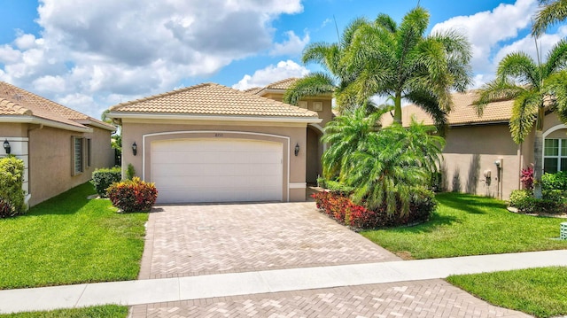 mediterranean / spanish-style house featuring a front lawn and a garage