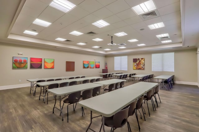 recreation room featuring ceiling fan, a drop ceiling, and dark wood-type flooring