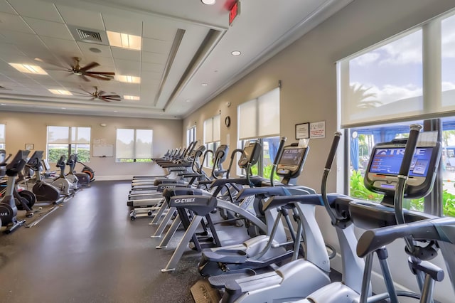 gym with a paneled ceiling and ceiling fan