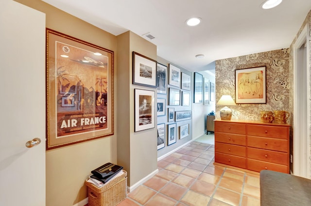 hallway featuring light tile patterned flooring and sink