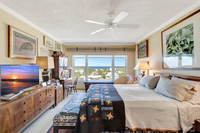 carpeted bedroom featuring a textured ceiling, ceiling fan, and ornamental molding