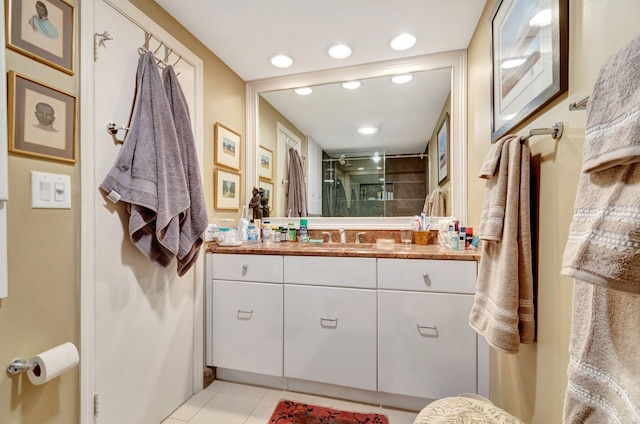 bathroom with tile patterned flooring, vanity, toilet, and walk in shower