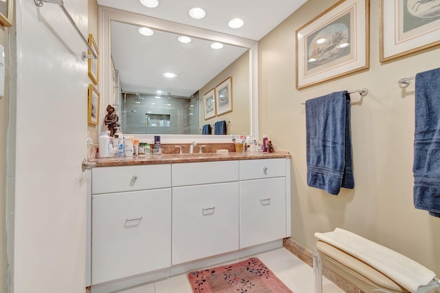 bathroom featuring tile patterned floors, a shower, and vanity