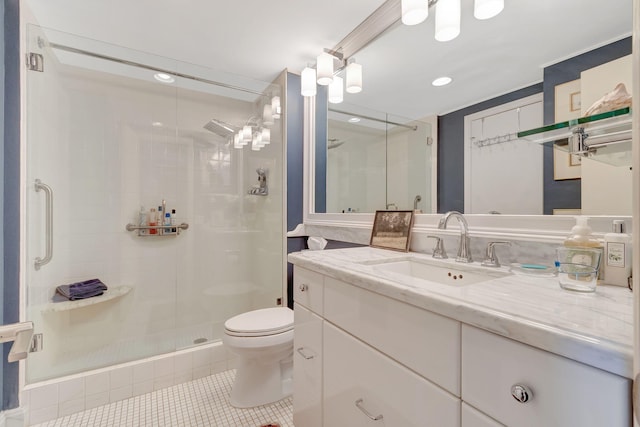 bathroom featuring tile patterned flooring, vanity, a shower with door, and toilet