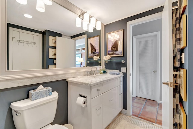 bathroom with tile patterned floors, crown molding, vanity, and toilet