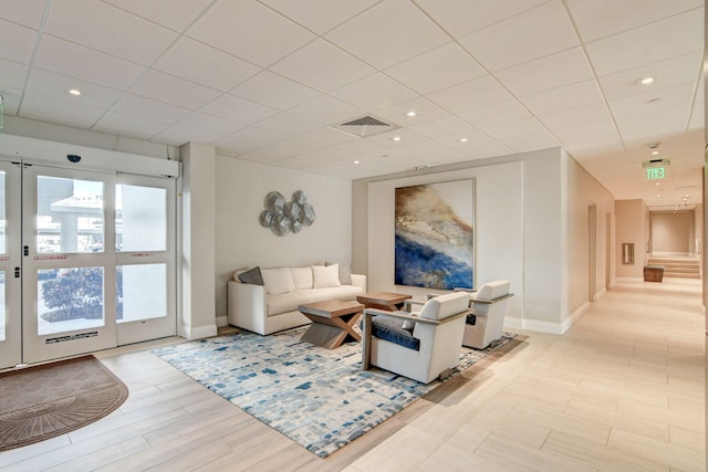 living room with light hardwood / wood-style floors and french doors