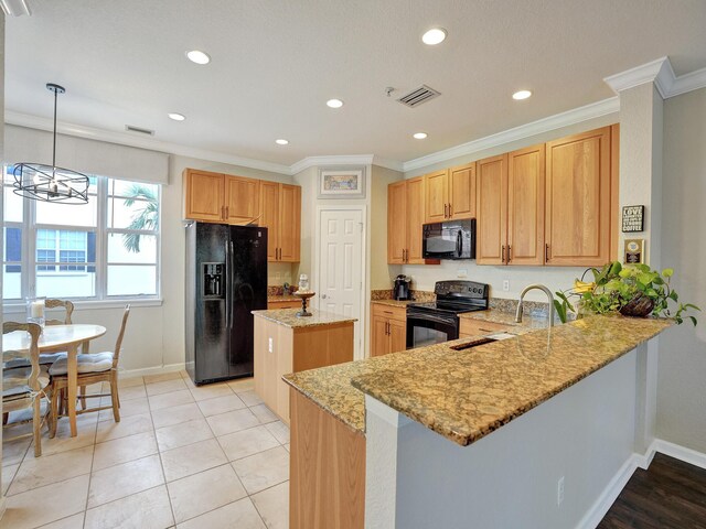 kitchen featuring black appliances, light stone countertops, kitchen peninsula, and sink