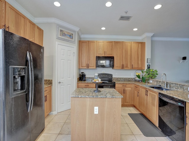 kitchen featuring light stone countertops, a center island, light brown cabinetry, black appliances, and ornamental molding