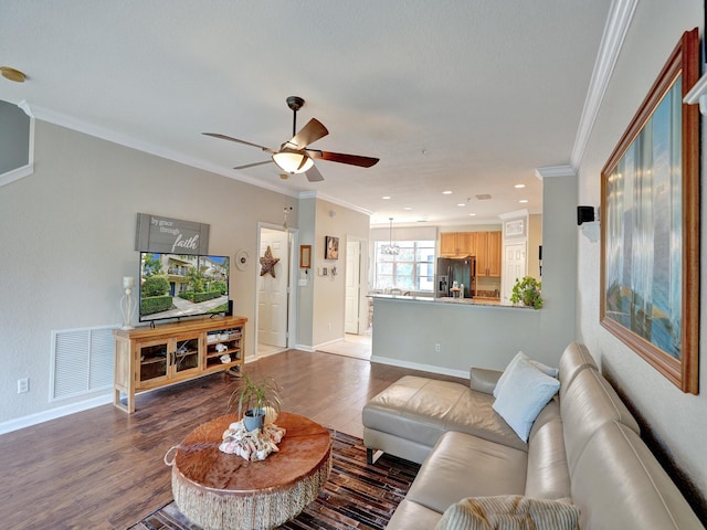 living room with hardwood / wood-style floors, ceiling fan, and ornamental molding