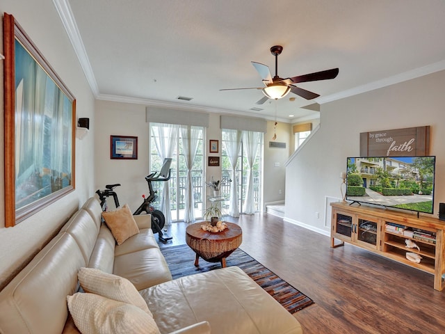 living room featuring dark hardwood / wood-style floors, ceiling fan, and ornamental molding