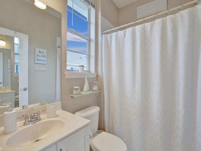 bathroom featuring vanity and toilet