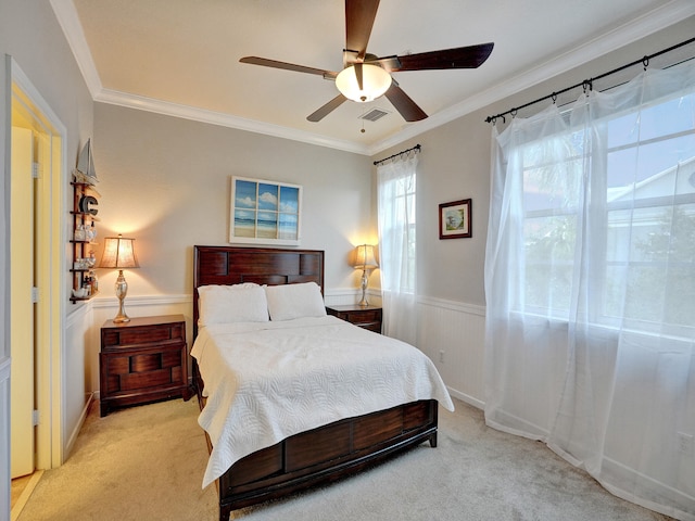 bedroom with ceiling fan, crown molding, and light colored carpet